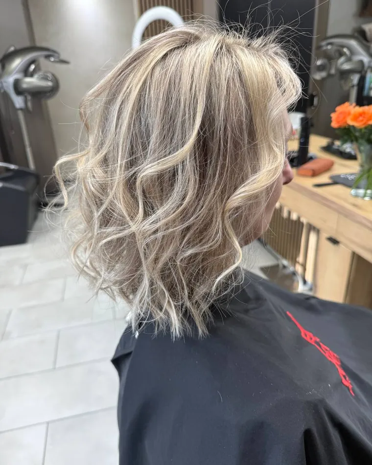 Rozvlněný blond bob po stylingu v salonu Newtone